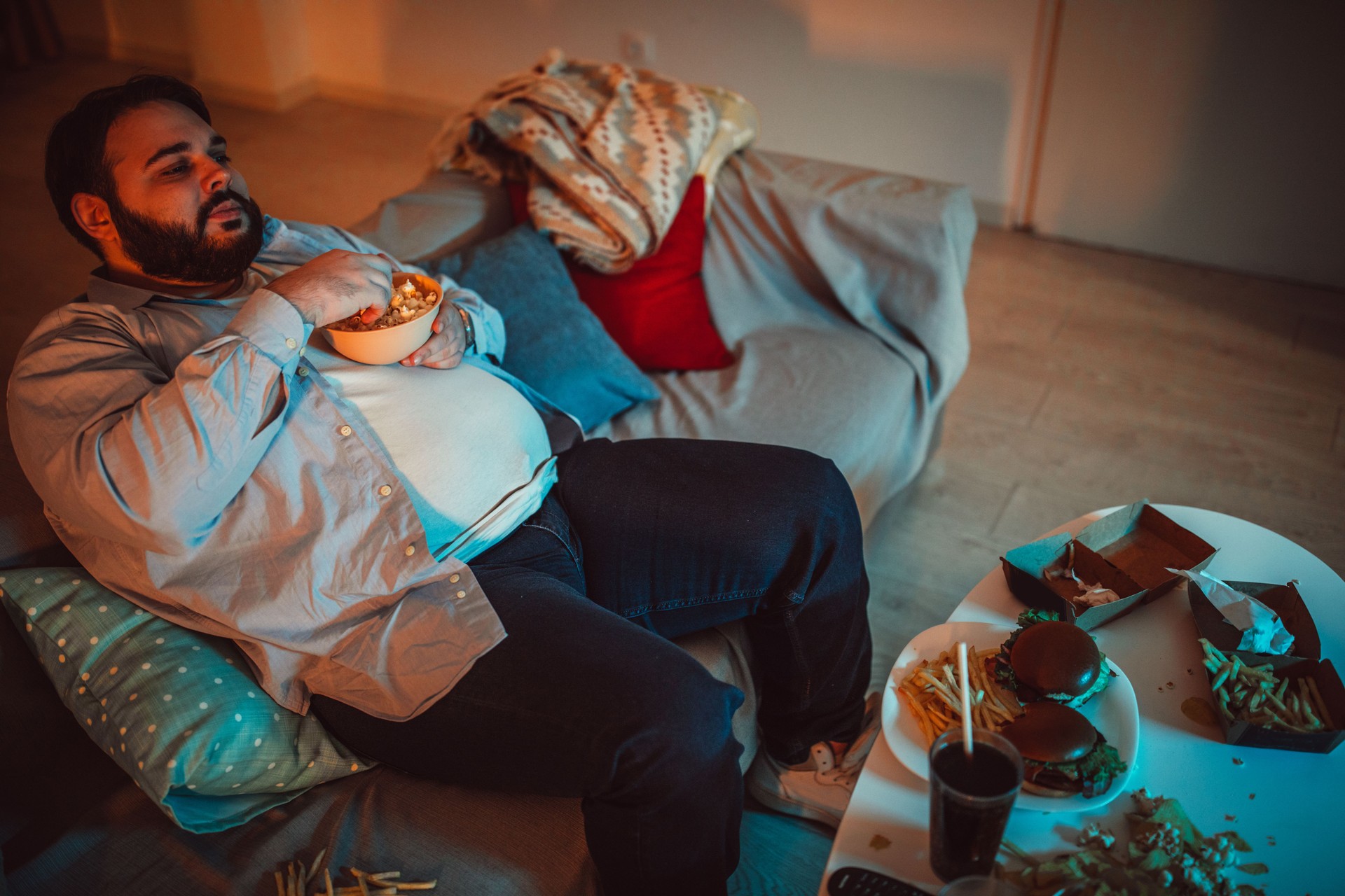 Fat man eating fast food