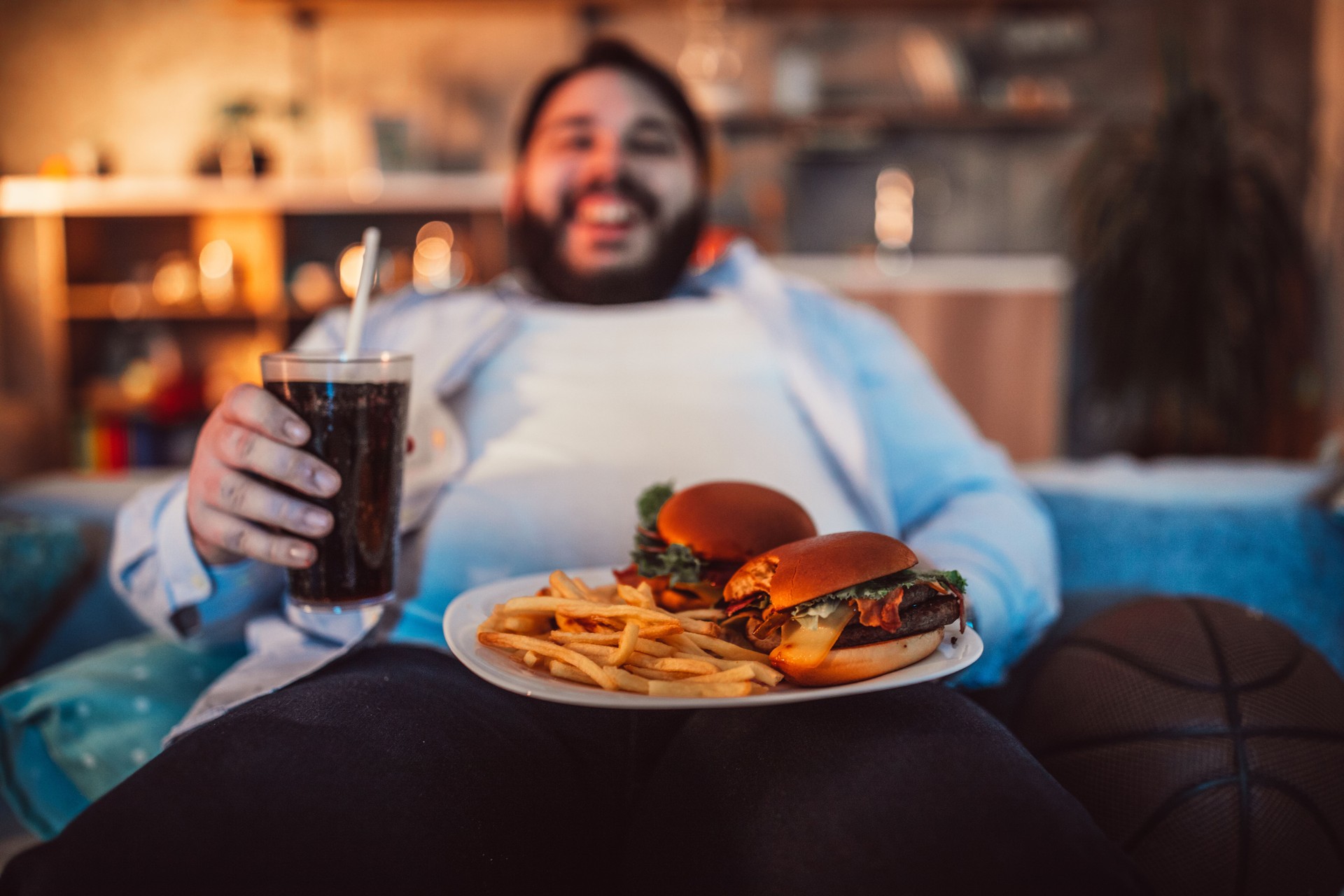 Chubby man eating junk food